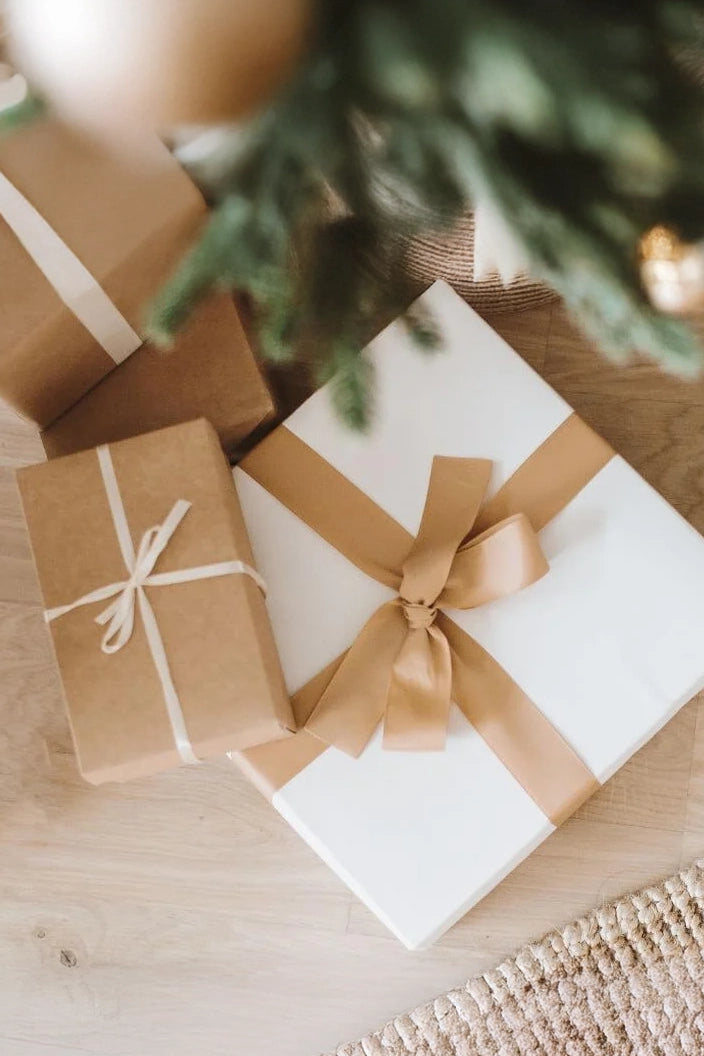 Gift boxes with ribbons under a Christmas tree