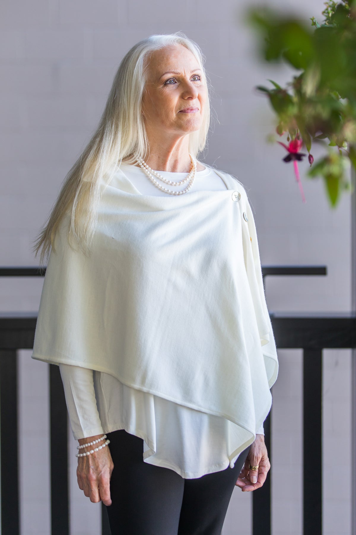 Model wearing a Chloe Angus Design Wool Button Wrap in Cream