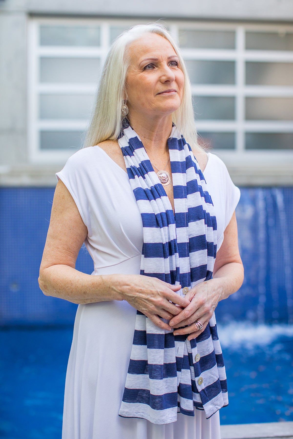 Model wearing a Chloe Angus Design Linen Button Wrap in Navy Stripe